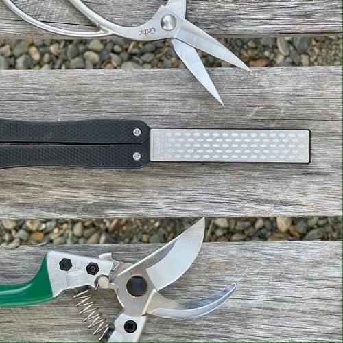 https://shop.thecelticfarm.com/cdn/shop/products/garden-tool-sharpener-diamond-carbon-steel-hone-reversible-paddle-for-sharpening-pruners-clippers-mower-blades-and-scissors-477843_500x.jpg?v=1696823446